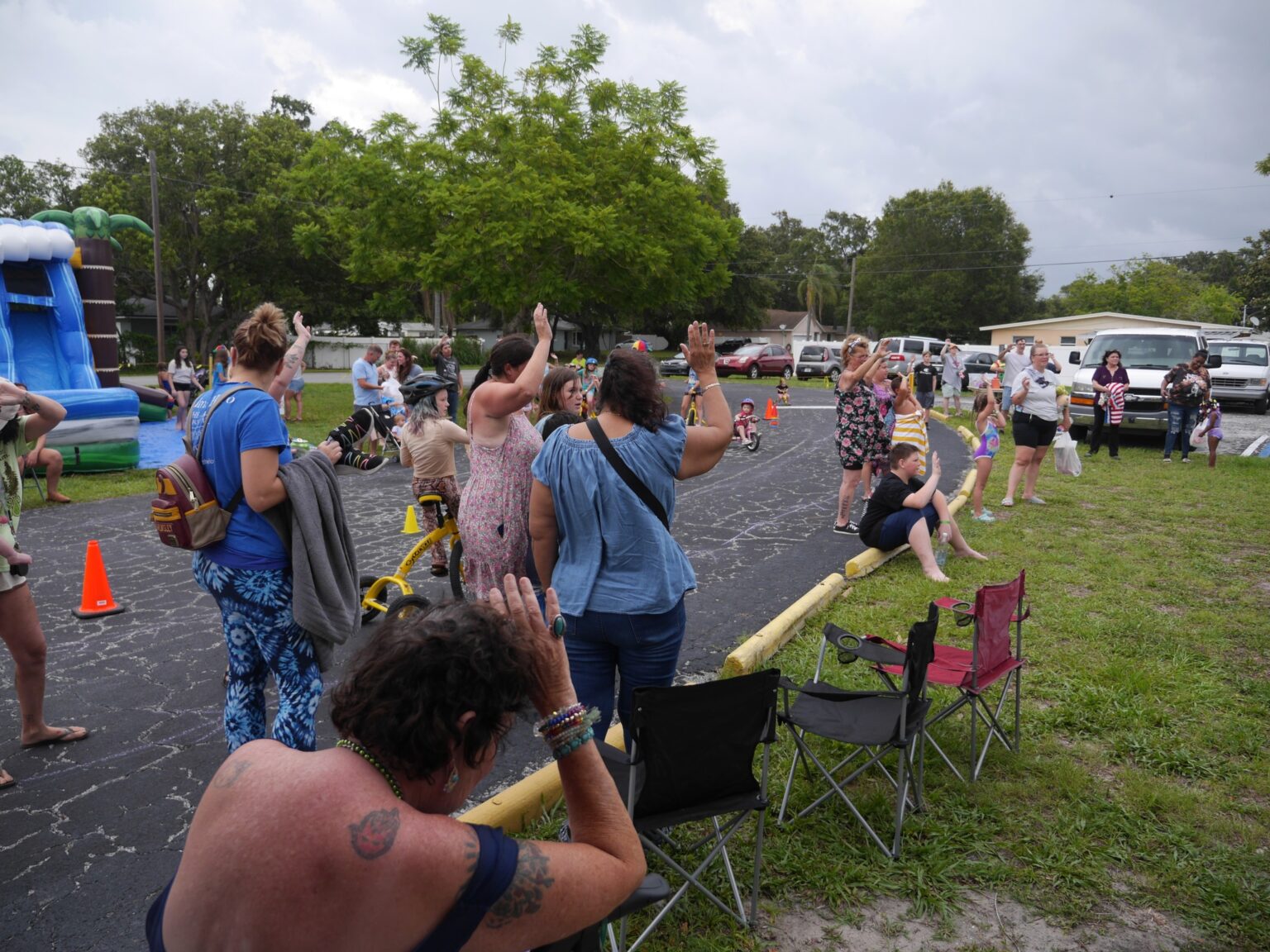 Group of neighbors waving at outdoor gathering