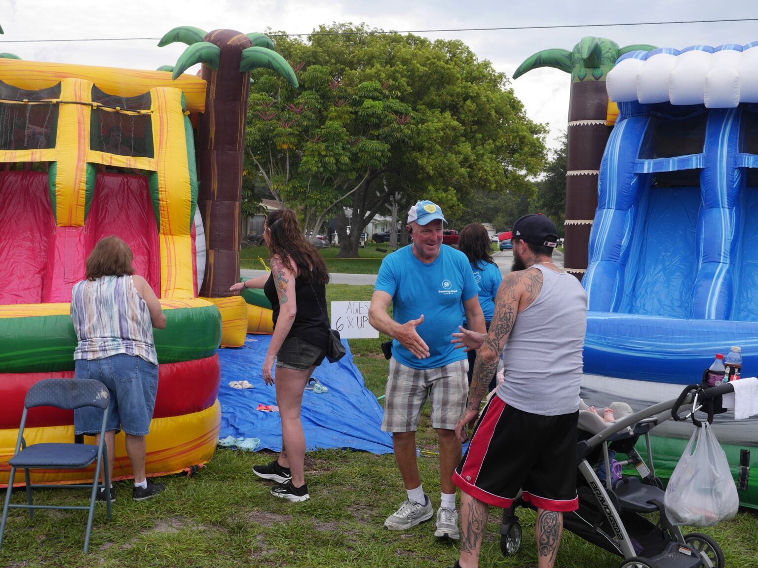 People enjoying colorful inflatable water slides